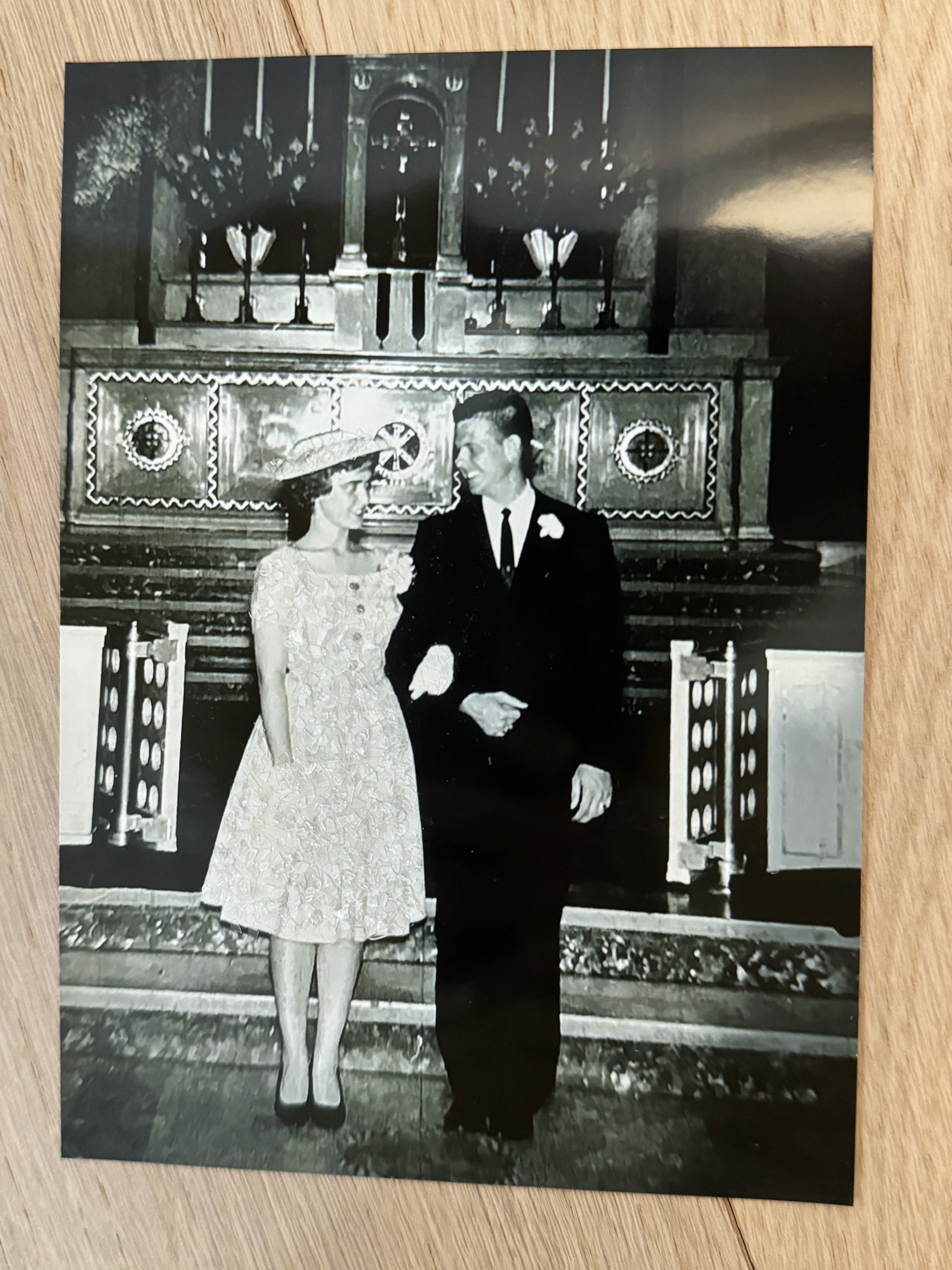 A sample photo print of a 1960's bride and groom with  bride's dress and hat sparkle bedazzled. 