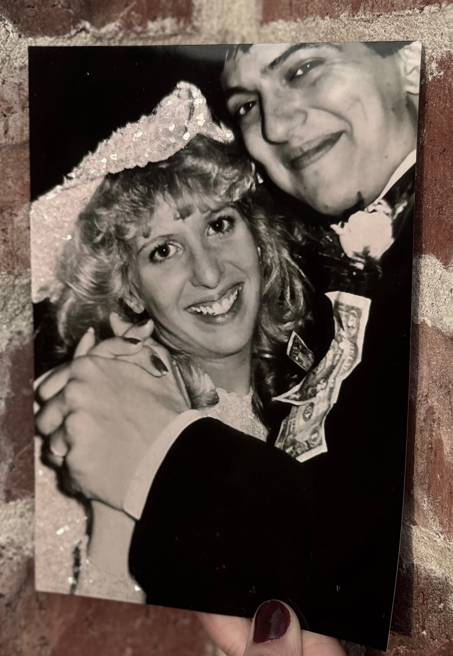  A sample of a family photo bride and groom dancing and smiling, with bride's gown and hat sparkle bedazzled. 