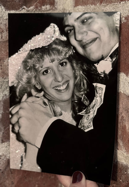  A sample of a family photo bride and groom dancing and smiling, with bride's gown and hat sparkle bedazzled. 