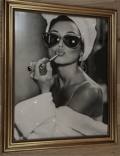 An Audrey Hepburn-inspired glamorous  lady with bedazzled towel head wrap and robe in gold frame. 