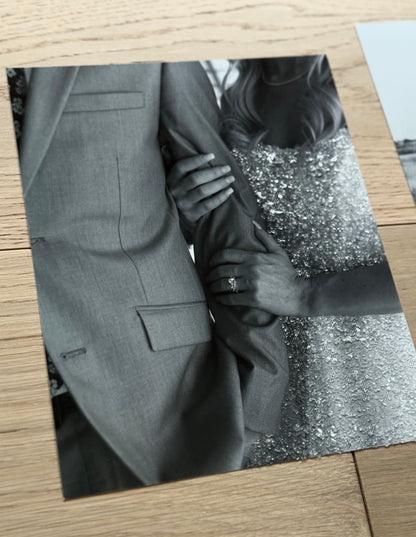 A sample sparkled photo print of a bride with sparkle bedazzled gown and ring, holding onto groom's arm.