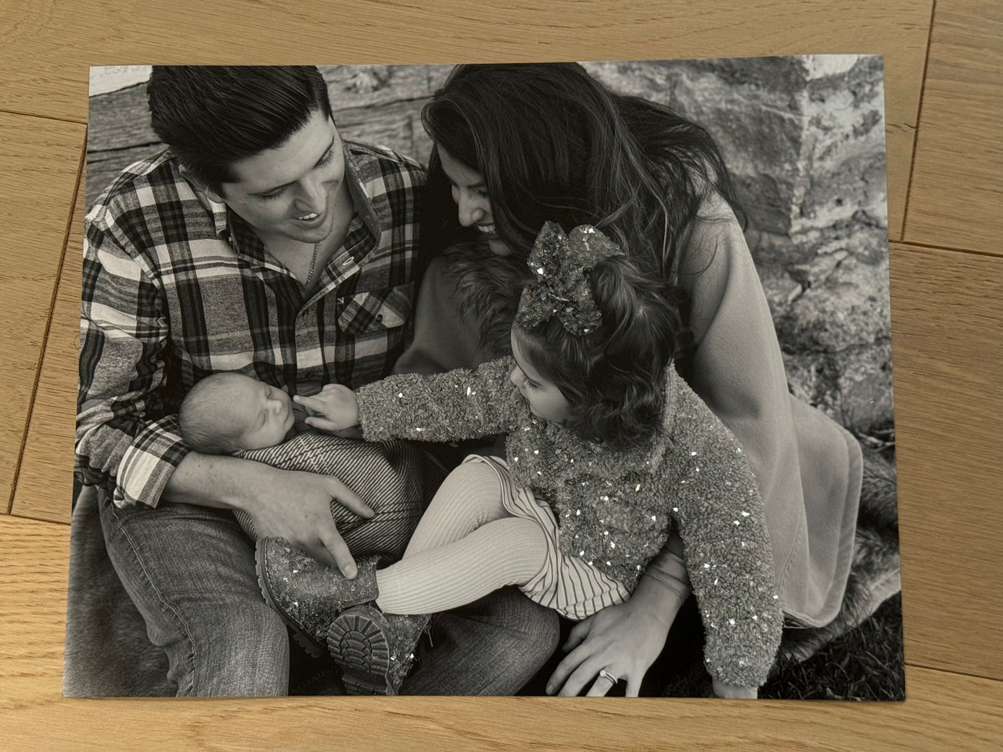 A sample of a family photo of a mother, father, toddler and baby, with sparkle embellished children's outfit.