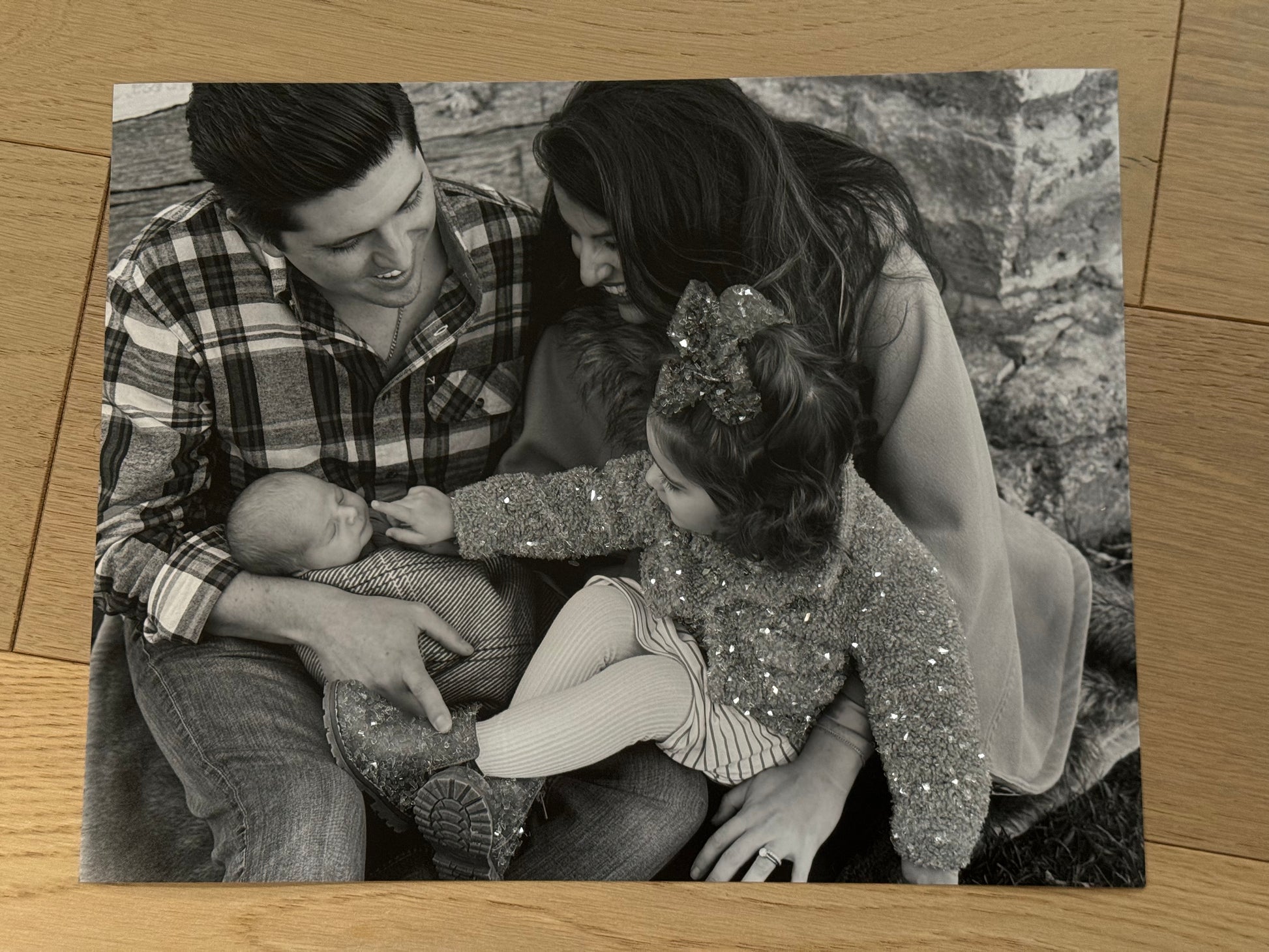 A sample of a family photo of a mother, father, toddler and baby, with sparkle embellished children's outfit.