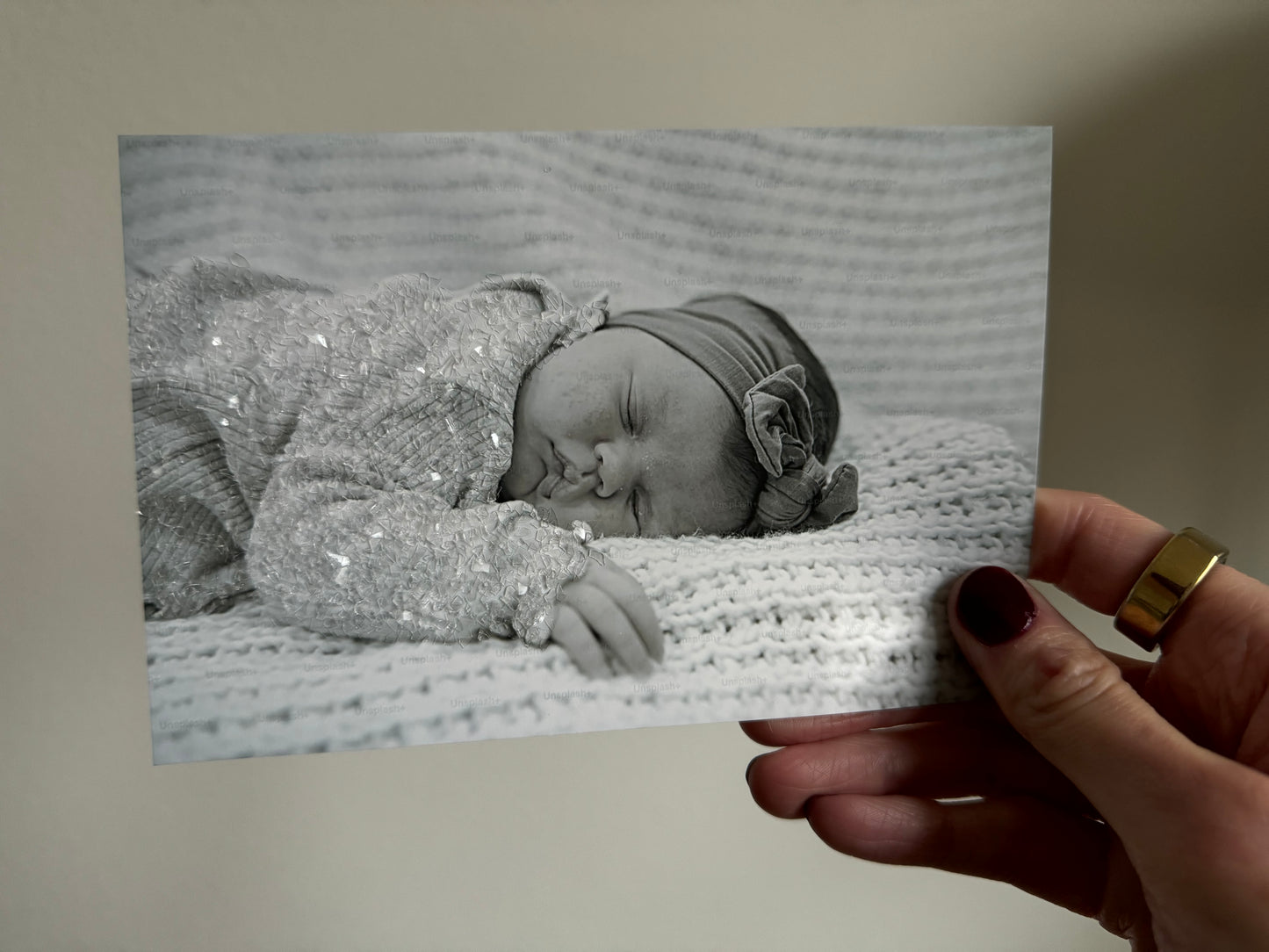 A sample print of a sleeping baby with sparkle bedazzled outfit. 