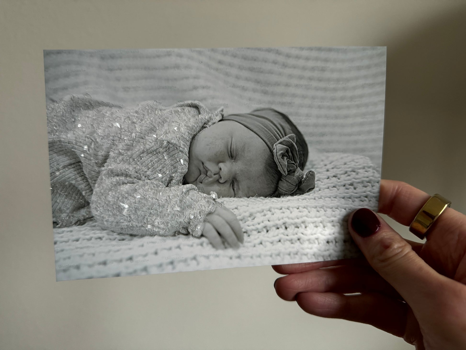 A sample print of a sleeping baby with sparkle bedazzled outfit. 