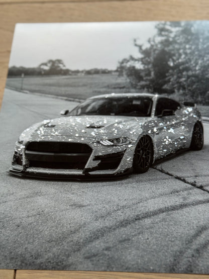 A sample of a photograph with a sports car embellished with sparkles. 